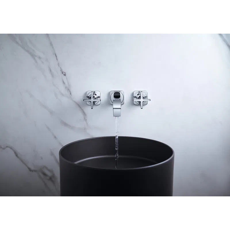 Modern bathroom faucet with water flowing into a sleek black basin against marble wall.