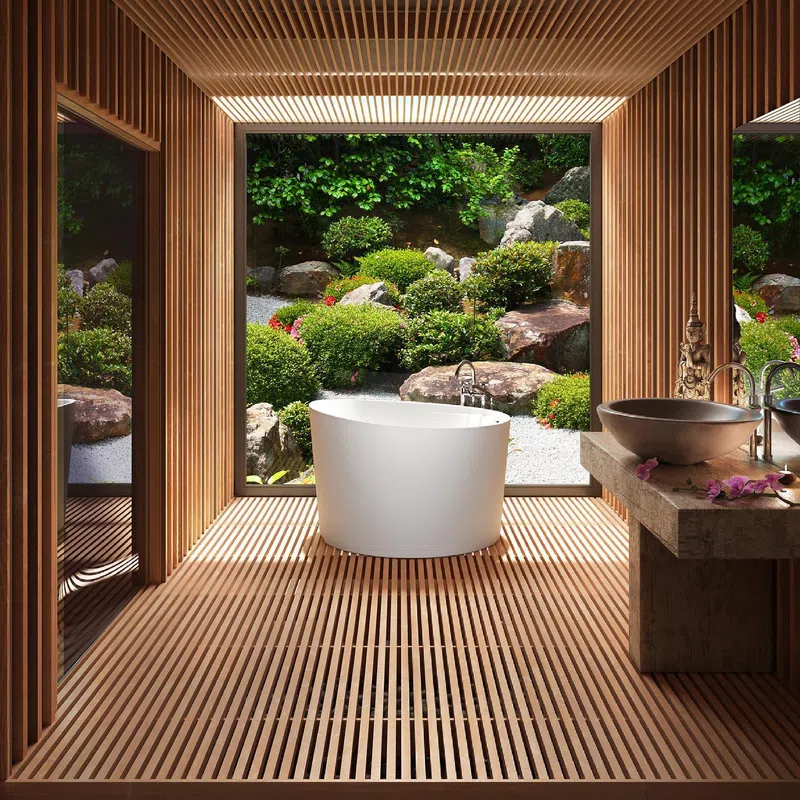 Modern bathroom with freestanding white tub and wood slat walls overlooking lush Japanese rock garden.