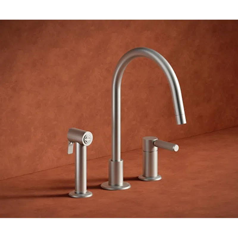 Brushed stainless steel modern kitchen faucet with side sprayer and single lever on a rust-colored countertop.