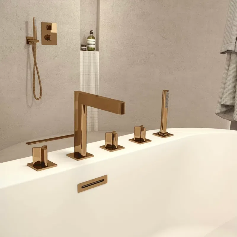 Modern bathroom with white bathtub featuring sleek bronze faucet and matching shower fixtures