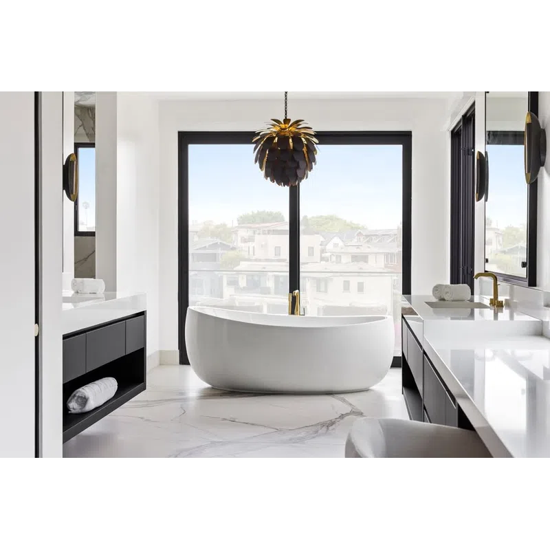 Modern bathroom with freestanding white tub, marble flooring, black cabinetry, large window, and stylish pendant light.
