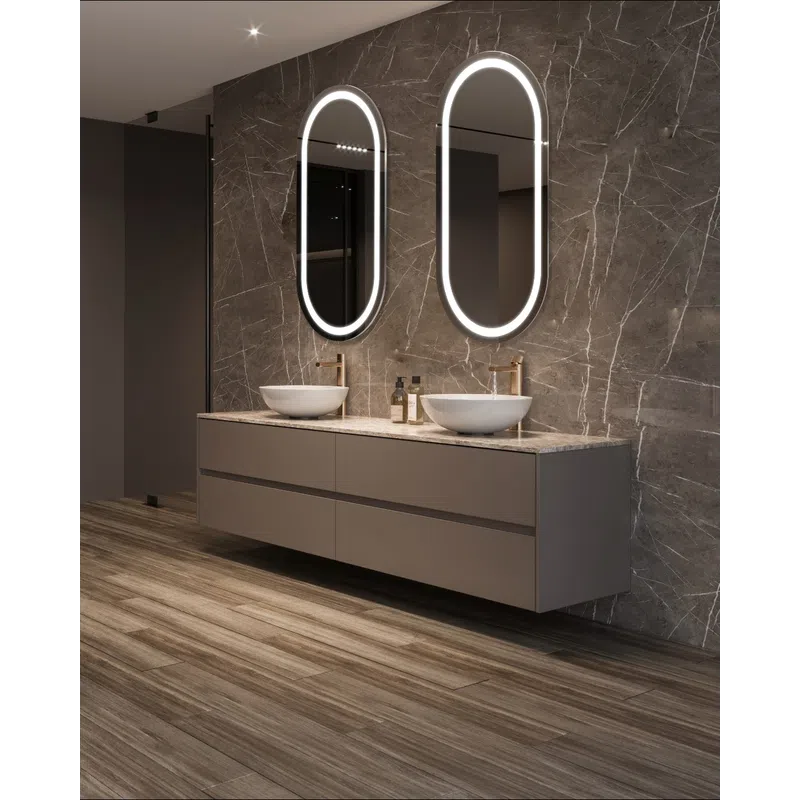 Modern bathroom with floating vanity, dual vessel sinks, oval LED mirrors, and marble wall with wood-look flooring.