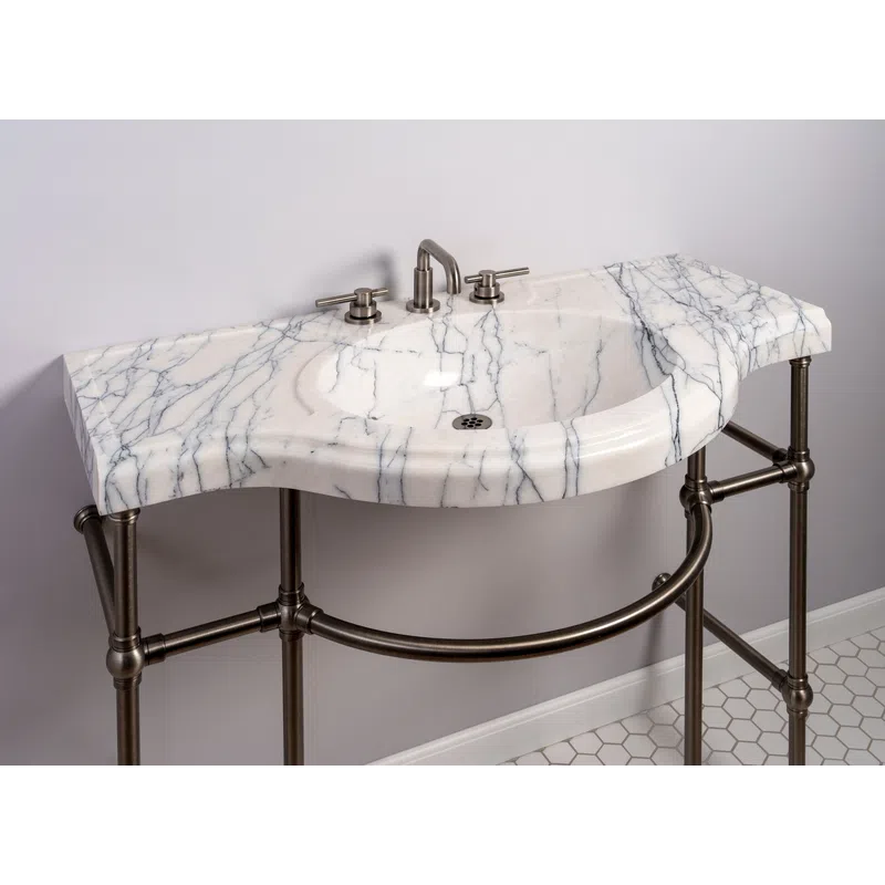 White marble bathroom sink with grey veining and brushed metal fixtures on bronze frame stand.
