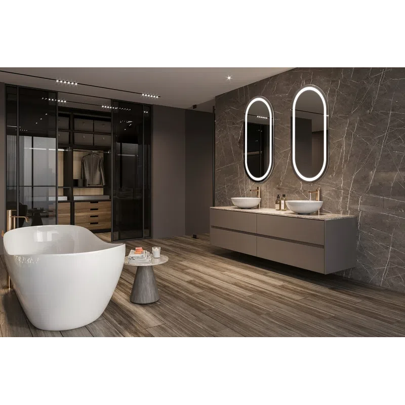 Modern bathroom with freestanding tub, dual vessel sinks, illuminated oval mirrors, and walk-in closet with glass doors.