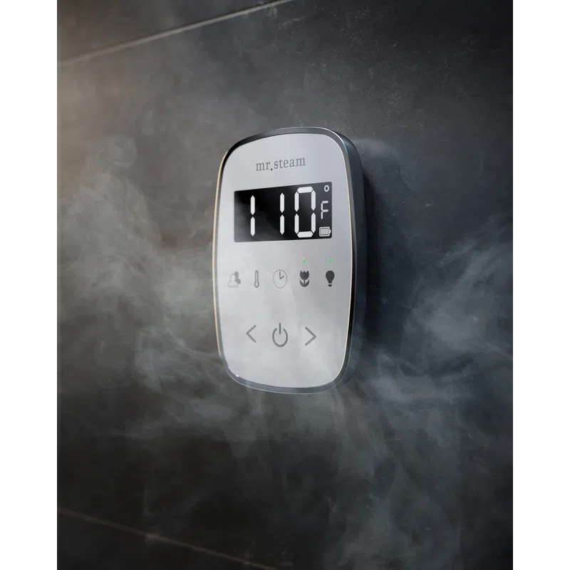 Digital steam shower control panel showing 110°F with visible steam around it on a dark tiled wall