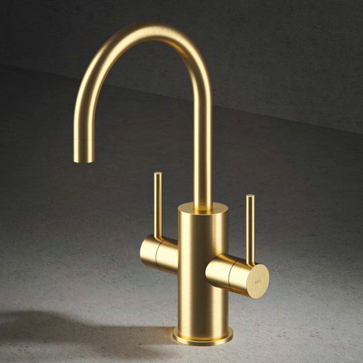 Modern matte gold kitchen faucet with dual handles on gray stone countertop and dark background.