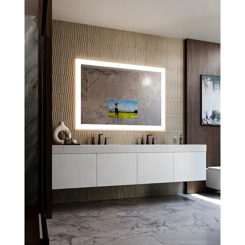 Modern bathroom with illuminated rectangular mirror, floating white vanity, marble floor, and decorative wall tiles.