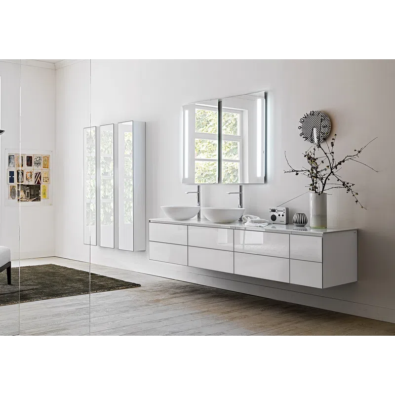 Modern bathroom with double vessel sinks, illuminated mirror, and sleek white floating vanity under window.
