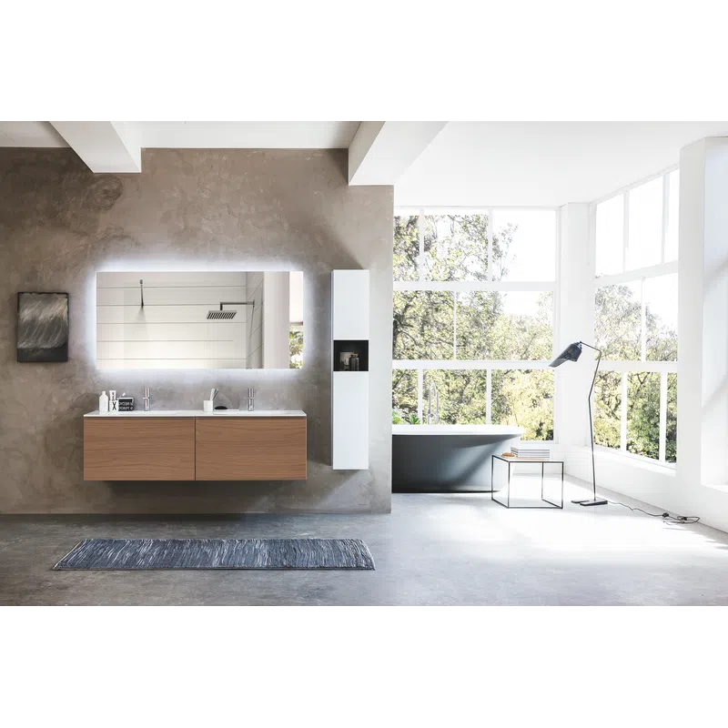 Modern bathroom with floating wooden vanity, illuminated mirror, gray bathtub, large windows, and concrete floor.