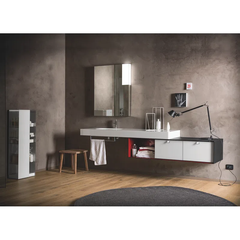 Modern bathroom with floating vanity, large mirror, wooden stool, and minimalist decor on textured gray wall.
