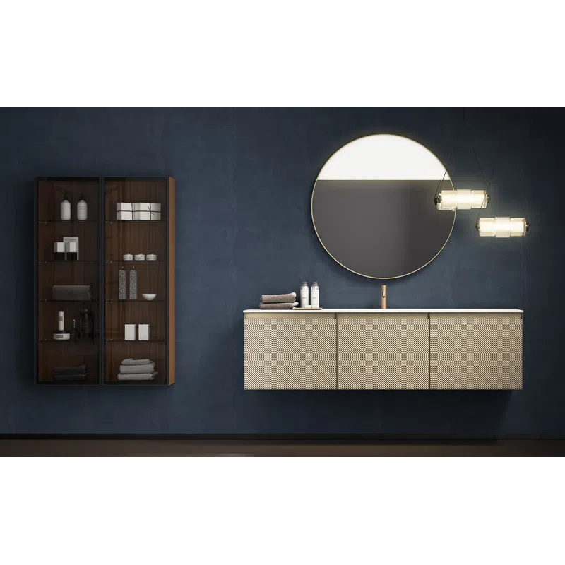 Modern bathroom with dark blue walls, floating vanity with textured drawers, round mirror, and glass cabinet.