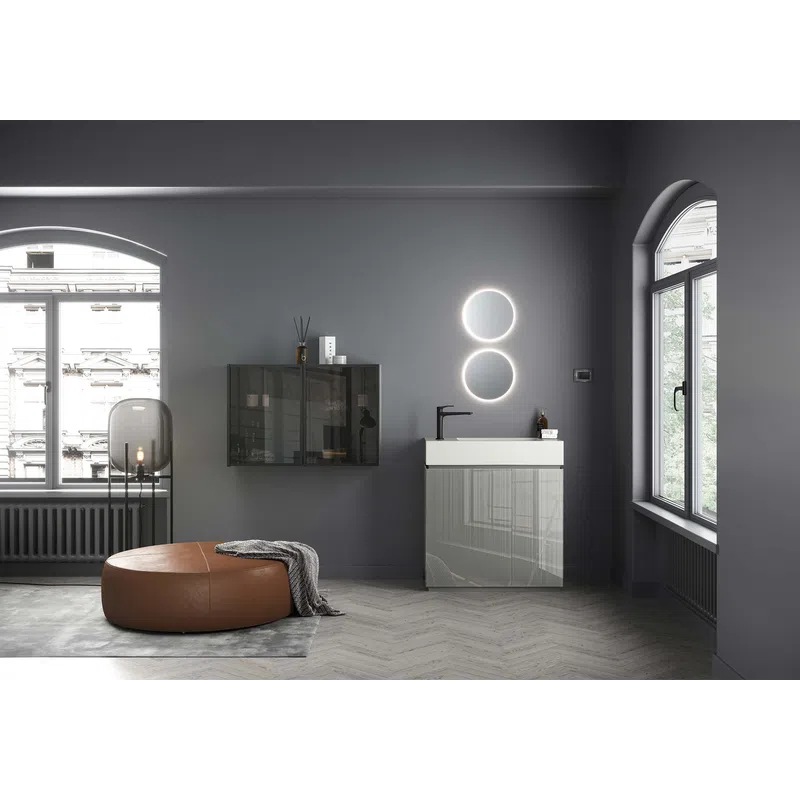 Modern bathroom with round illuminated mirrors, gray vanity, leather ottoman, and large arched windows with city view.