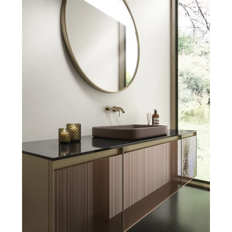 Modern bathroom vanity with a round mirror, matte black countertop, mauve sink, and glass cabinet doors by a large window.
