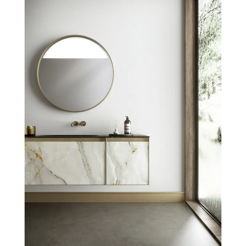 Modern bathroom vanity with marble cabinet, round mirror, gold faucet, and large window with natural light.