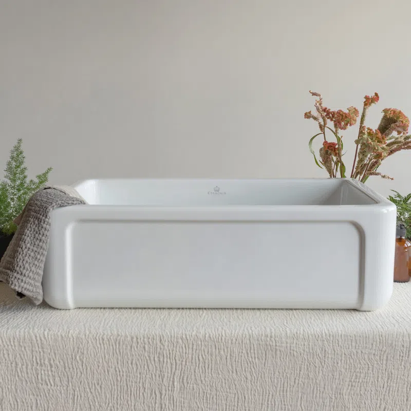 White rectangular ceramic sink on textured beige fabric with towel and dried floral decoration