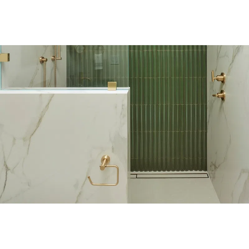 Modern bathroom shower with green ribbed tiles, gold fixtures, glass partition, and marble walls under recessed lighting