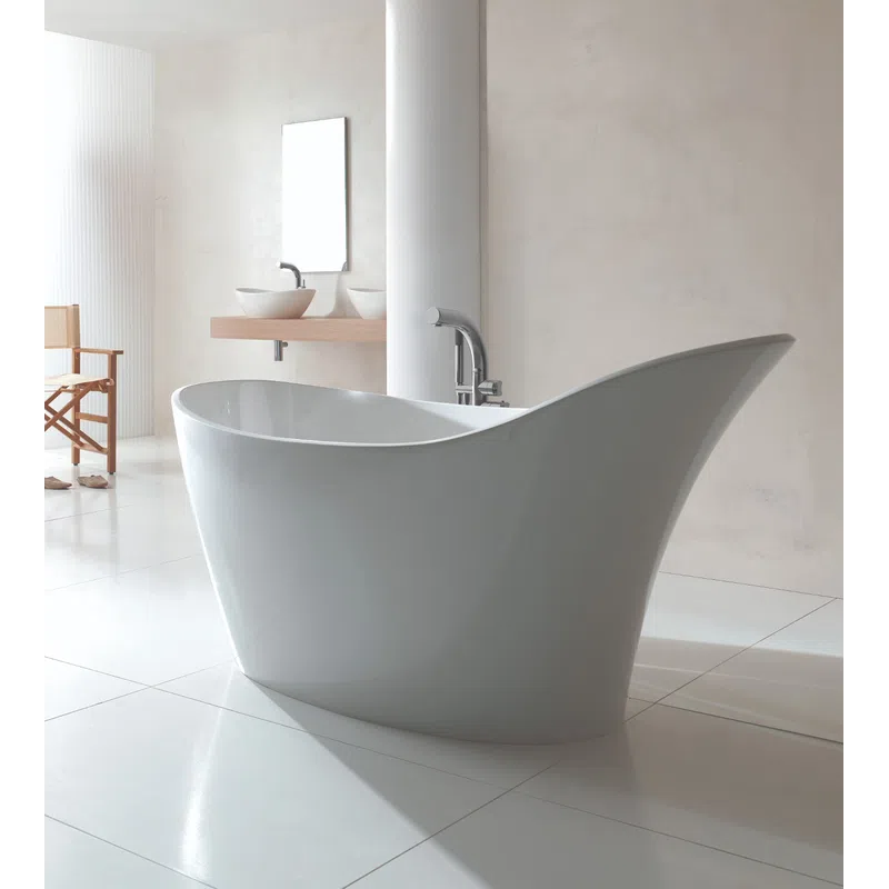 Modern freestanding white bathtub in a minimalist bathroom with white walls and wooden chair.