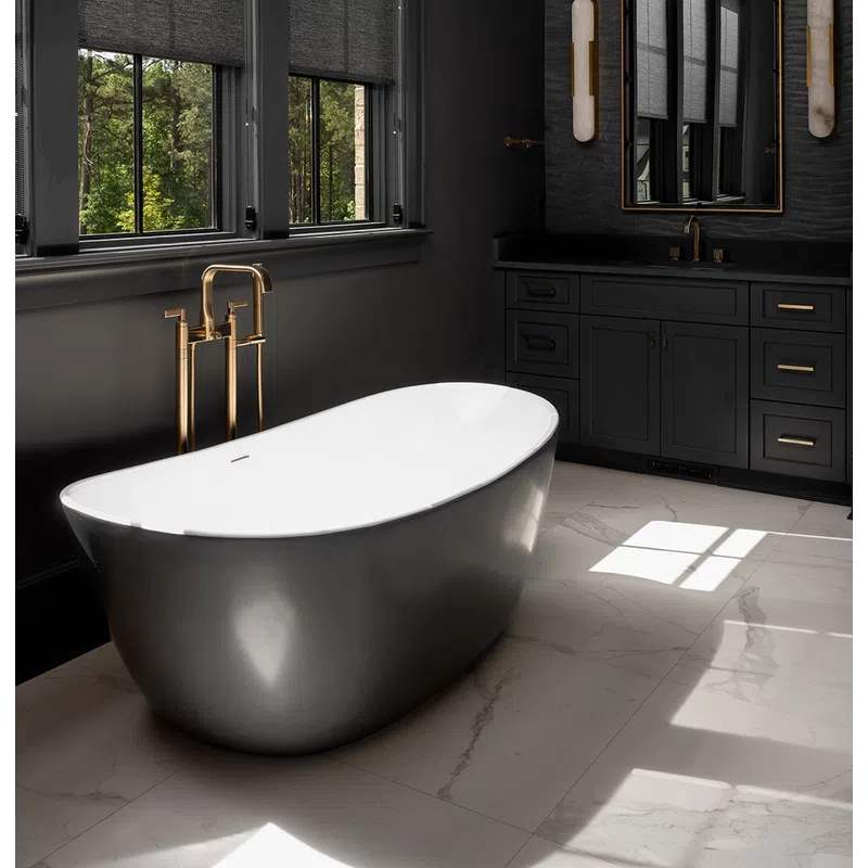 Modern bathroom with a sleek gray freestanding tub, brass fixtures, dark cabinetry, and marble flooring.