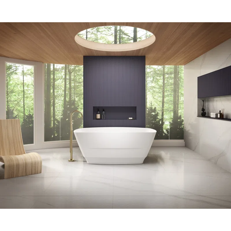 Modern bathroom with a white freestanding tub, wooden chair, skylight, and forest view through large windows.