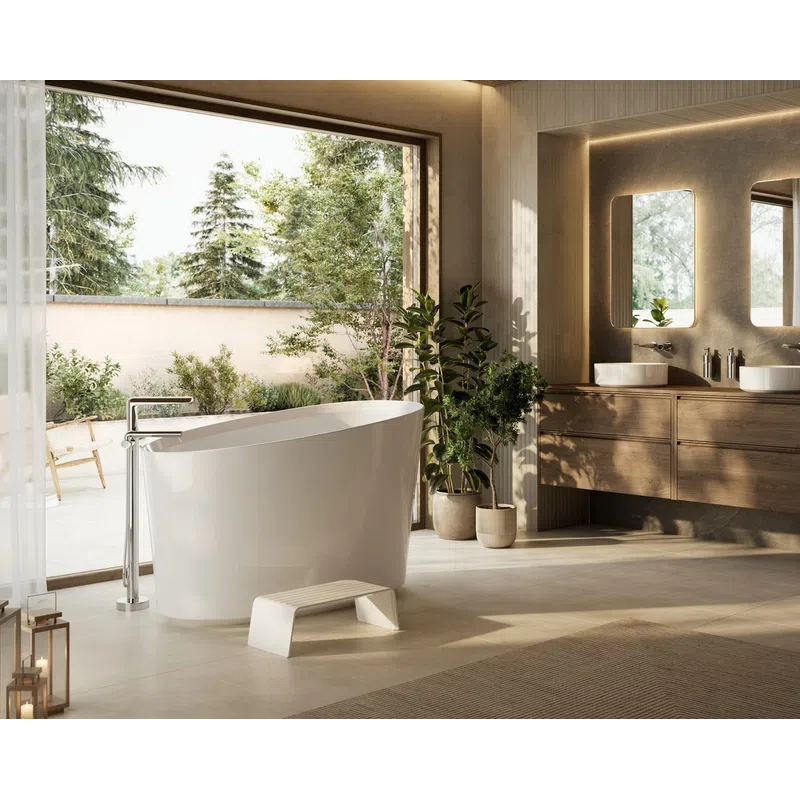 Modern bathroom with freestanding bathtub, wooden vanity, double sinks, plants, and large window showing outdoor greenery.