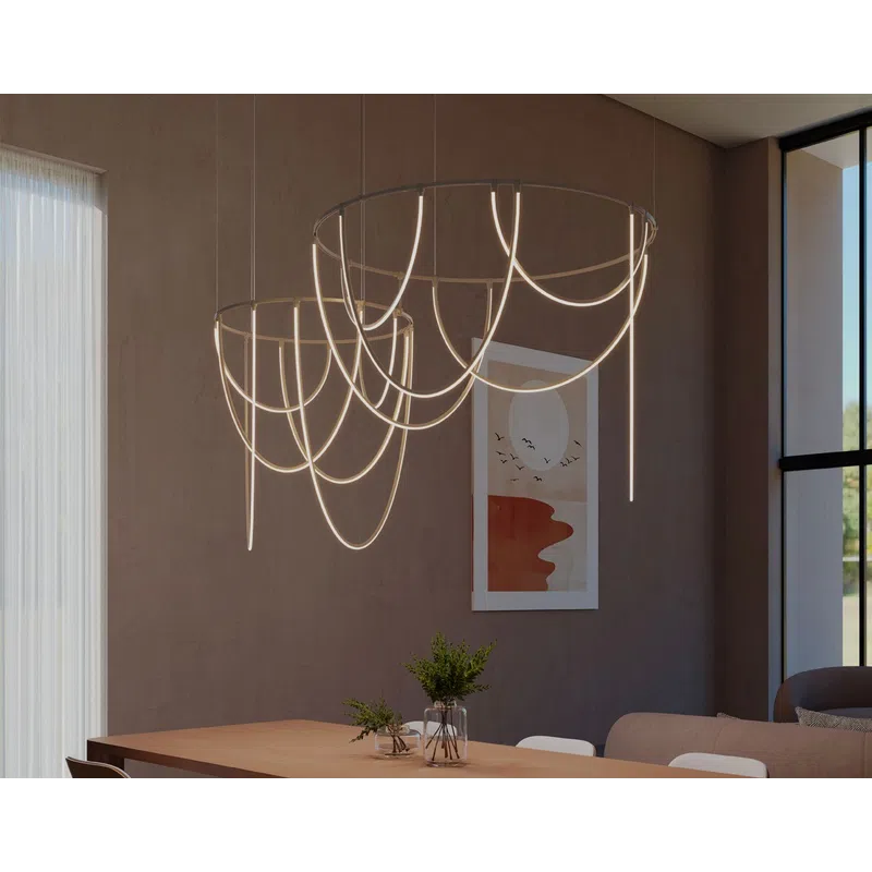 Modern satin white suspension lights over a wooden dining table in a minimalist living space with artwork and natural light.