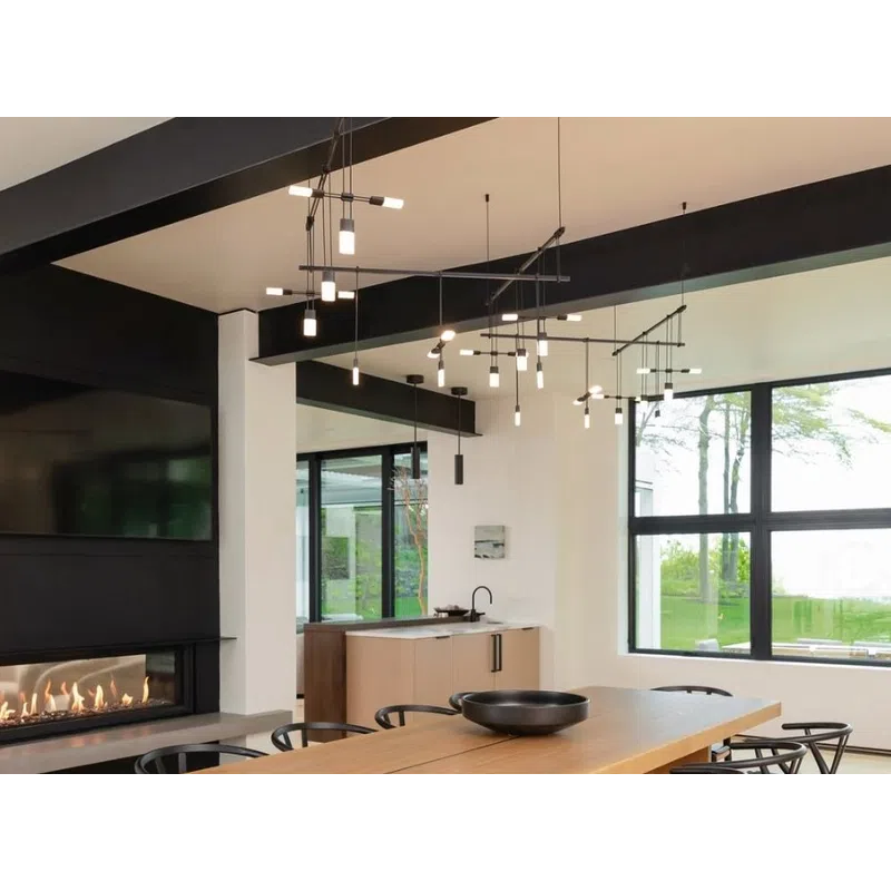 Modern dining room with wooden table, black chairs, large windows, and contemporary pendant lighting above.