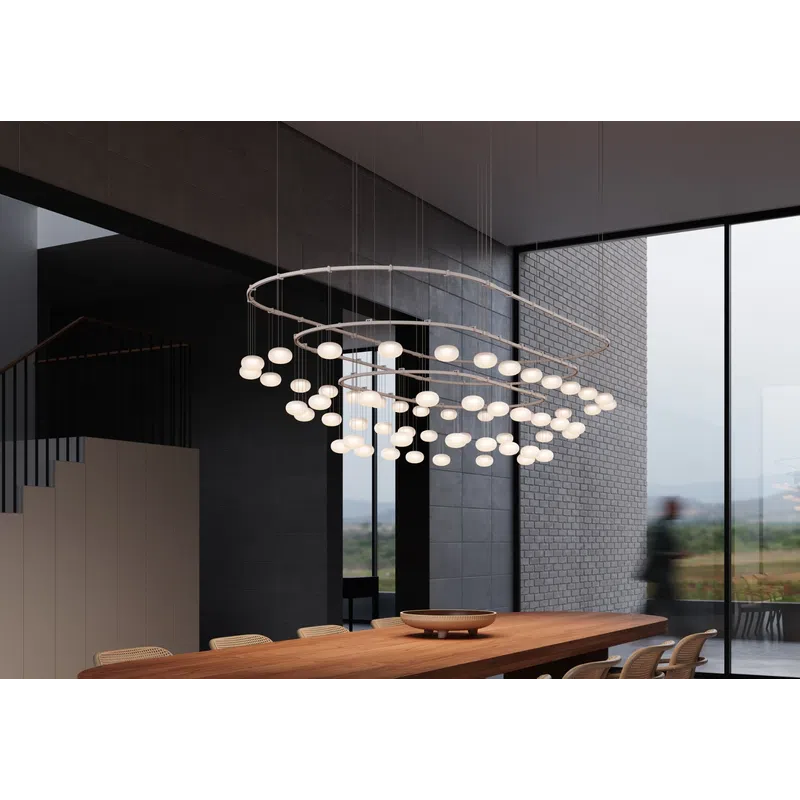 Modern dining room with a long wooden table, woven chairs, and circular globe pendant lighting.