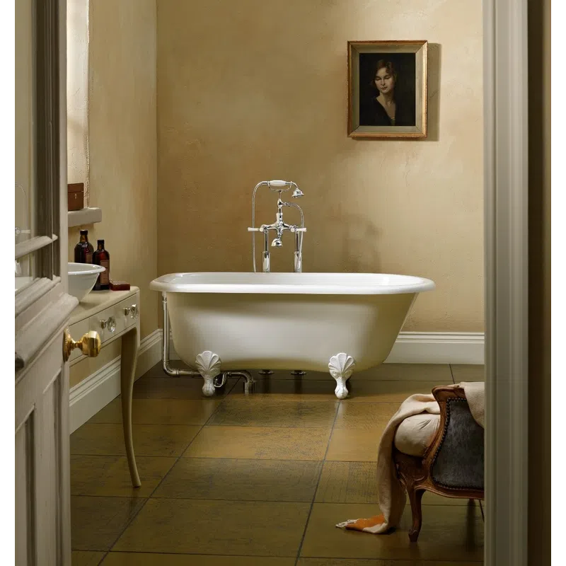 Vintage clawfoot bathtub with silver faucet in classic beige bathroom featuring a portrait and antique furniture.