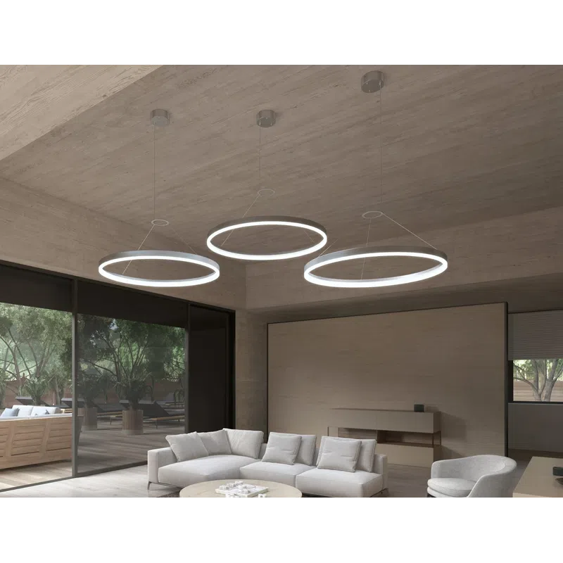 Modern living room with circular pendant lights, beige sofas, a round coffee table, and large glass doors.