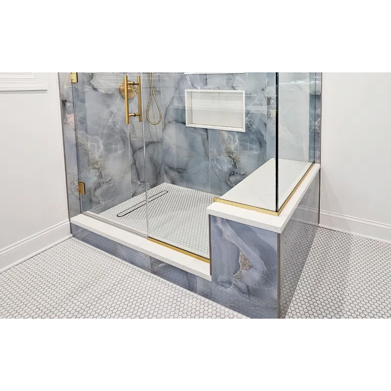 Modern bathroom shower with glass enclosure, gold fixtures, blue marble tiles, and built-in shelves.