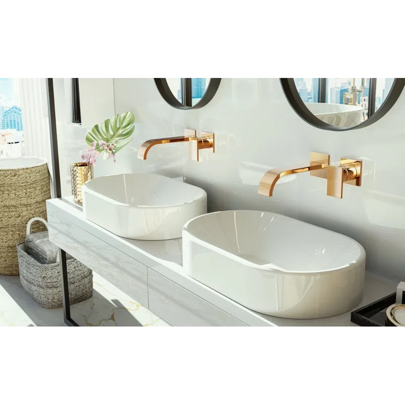 Modern bathroom with dual white vessel sinks, gold faucets, round mirrors, and decorative plants by a window.