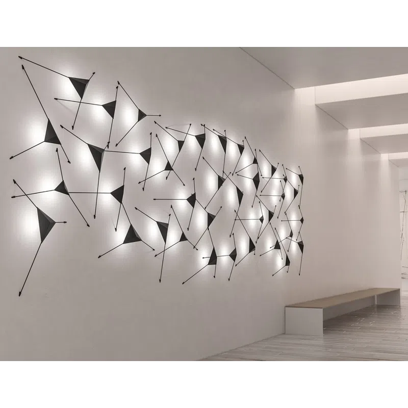 Modern hallway with illuminated abstract geometric wall art and a minimalist bench on light wood flooring.