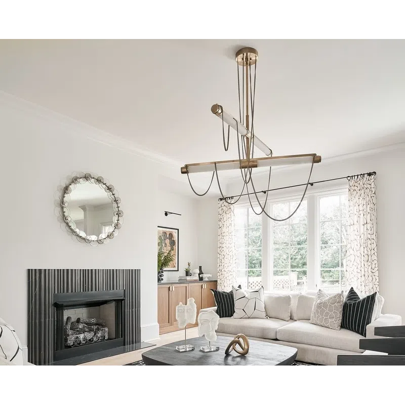Modern living room with beige sofas, black patterned rug, abstract coffee table, and large windows with curtains.