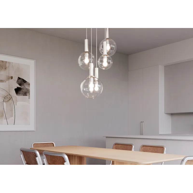Modern dining room with wooden table, six cane chairs, minimalist pendant lights, and neutral artwork on wall