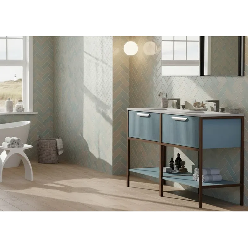 Modern bathroom with freestanding bathtub, blue vanity, wooden floor, and ocean view through large window