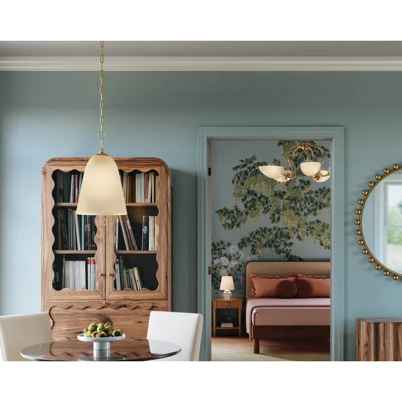Cozy dining area with round table, white chairs, wooden cabinet, and bedroom with floral wallpaper in the background.