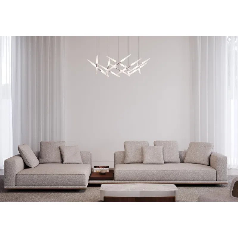 Minimalist living room with two beige sofas, modern pendant light, marble coffee table, and neutral tones.