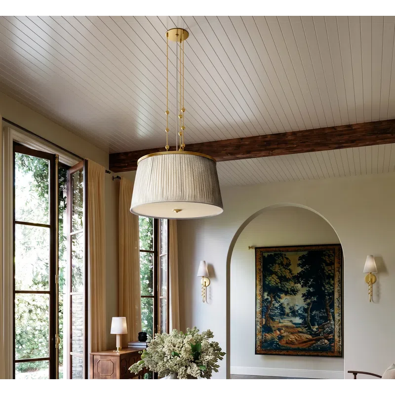 Elegant living space with large windows, vintage table and chair, floral centerpiece, and soft natural light.