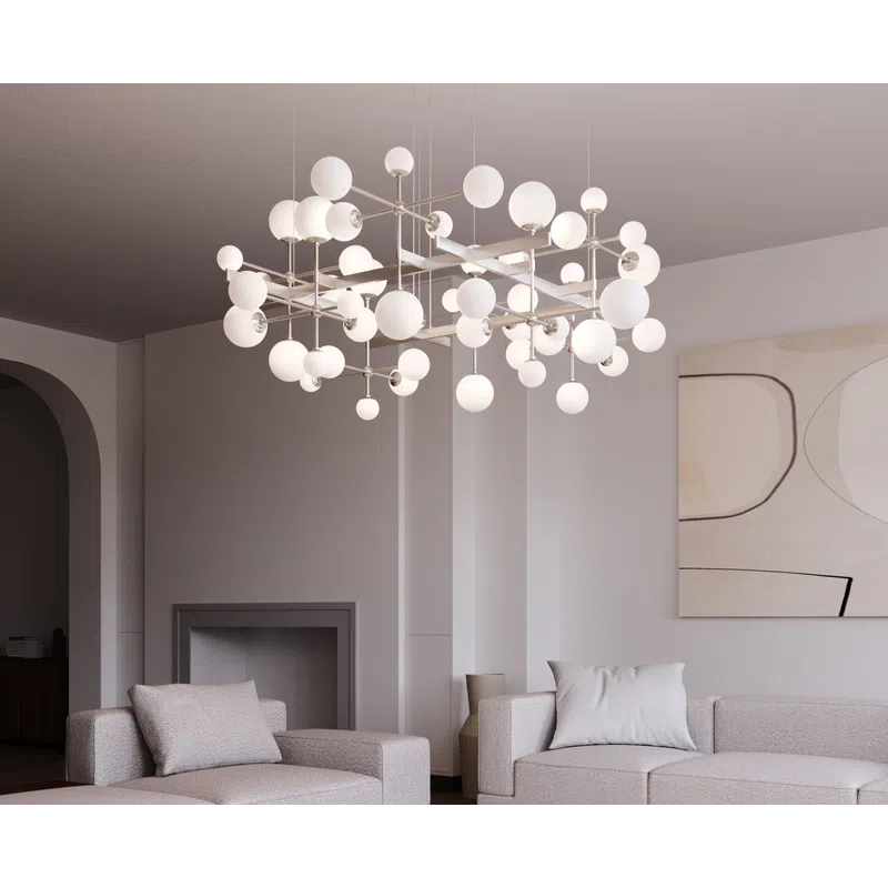 Modern living room with beige sofas, abstract wall art, marble coffee table, and a geometric chandelier.
