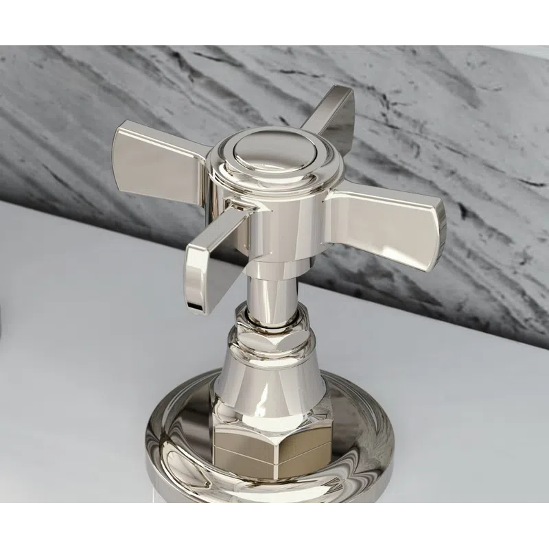 Close-up of a polished chrome faucet handle on a white marble countertop with gray veining background.