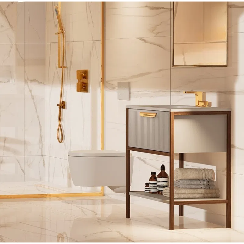 Luxury bathroom with marble walls, gold fixtures, wall-mounted toilet, and modern wooden vanity with towels.