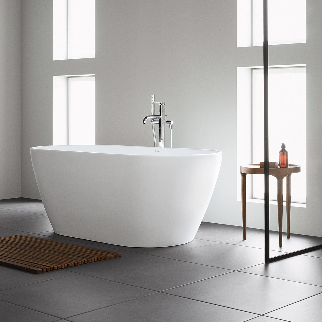 Modern freestanding bathtub in a minimalist bathroom with natural light and elegant decor.