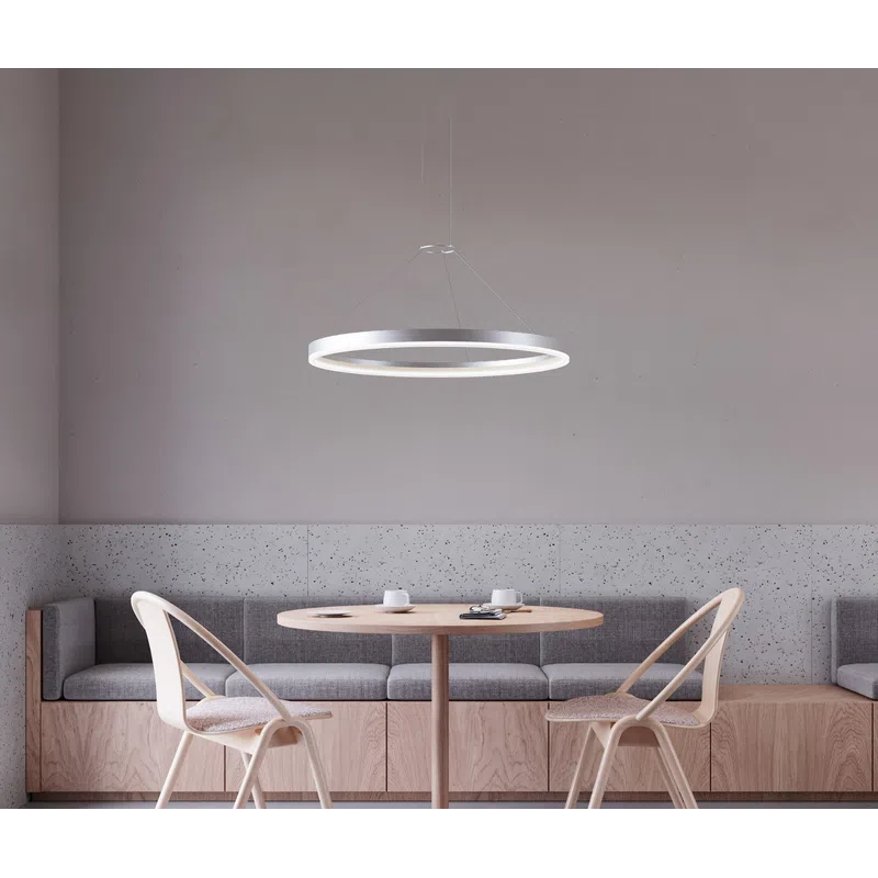 Minimalist dining area with round wooden table, two wooden chairs with cushions, bench seating, and circular pendant light.