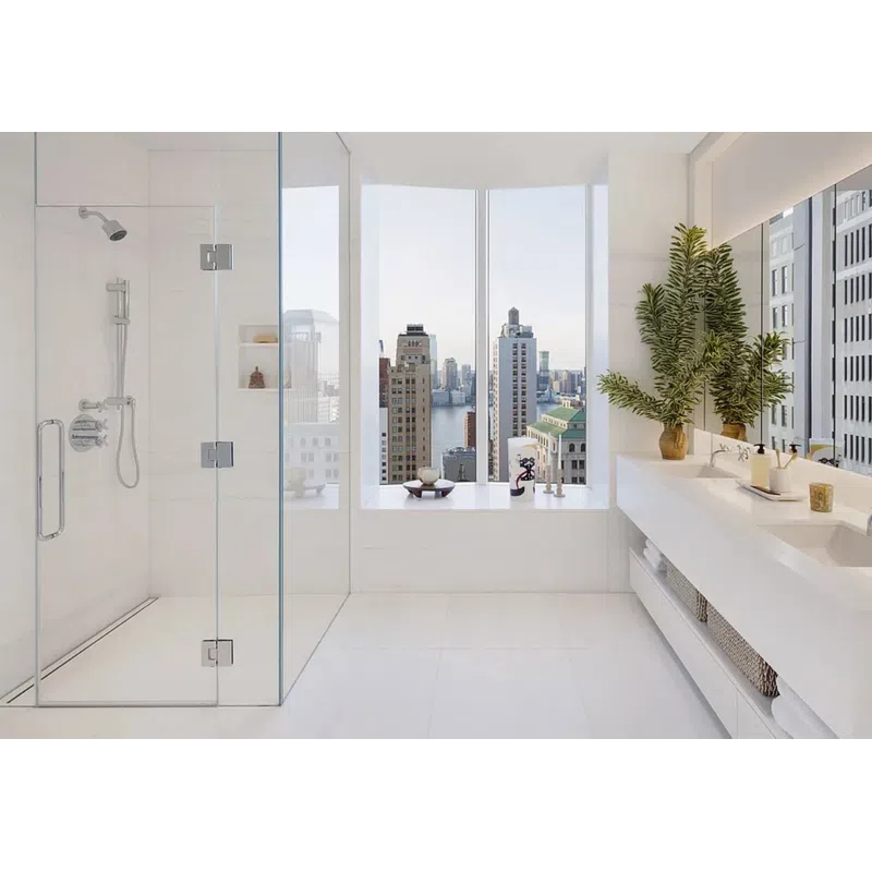 Bright modern bathroom with glass shower, double sink vanity, large plant, and city skyline view.
