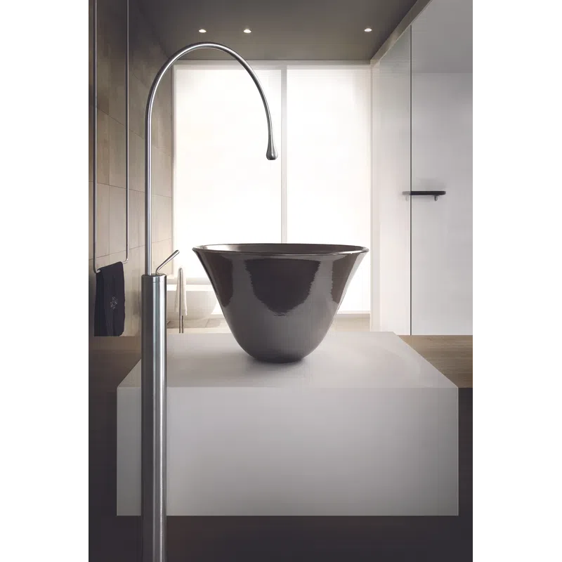 Modern bathroom sink with sleek black basin and tall curved stainless steel faucet on white counter.