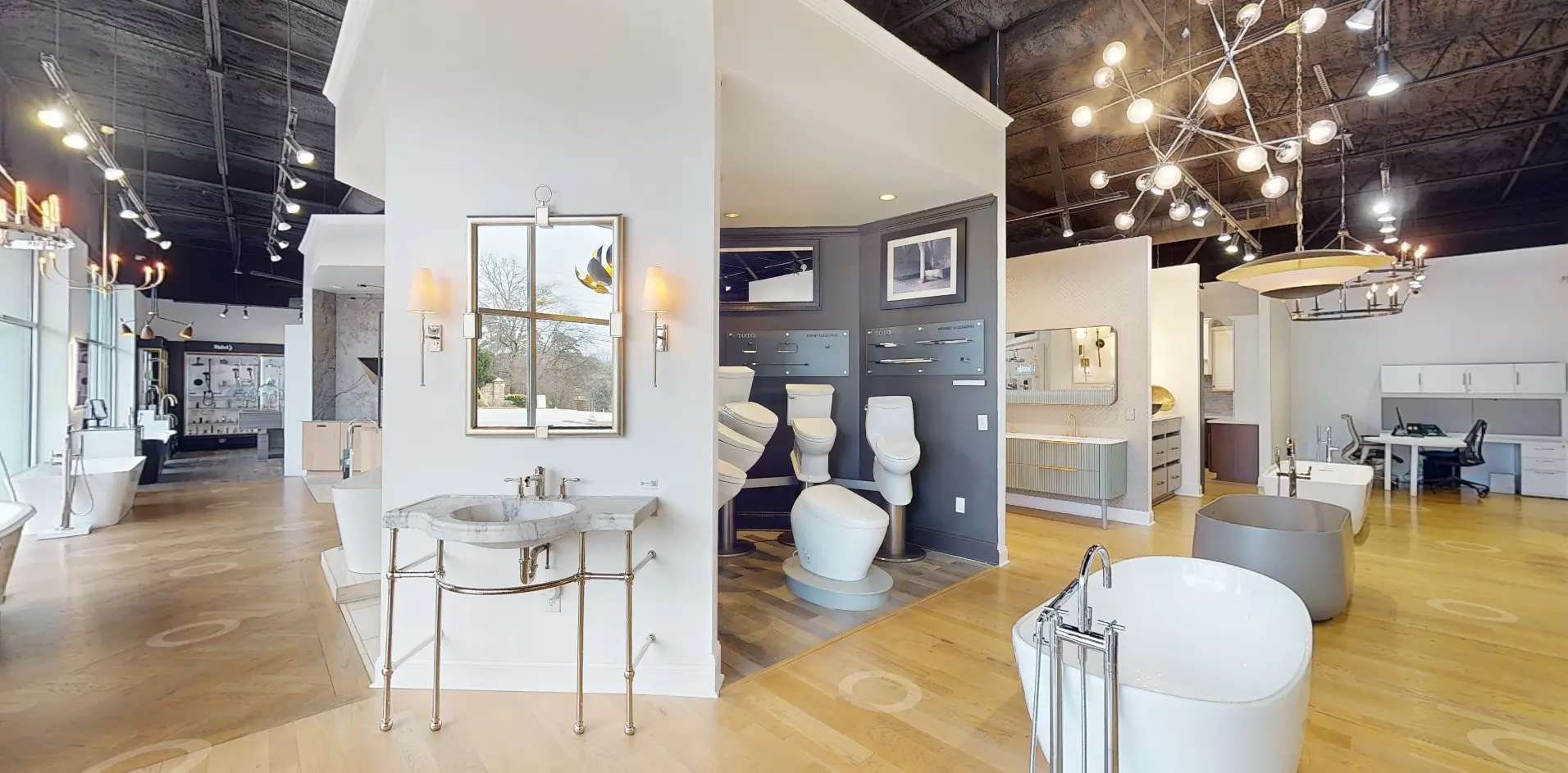 Modern showroom featuring elegant bathroom fixtures and chic lighting in a spacious design.