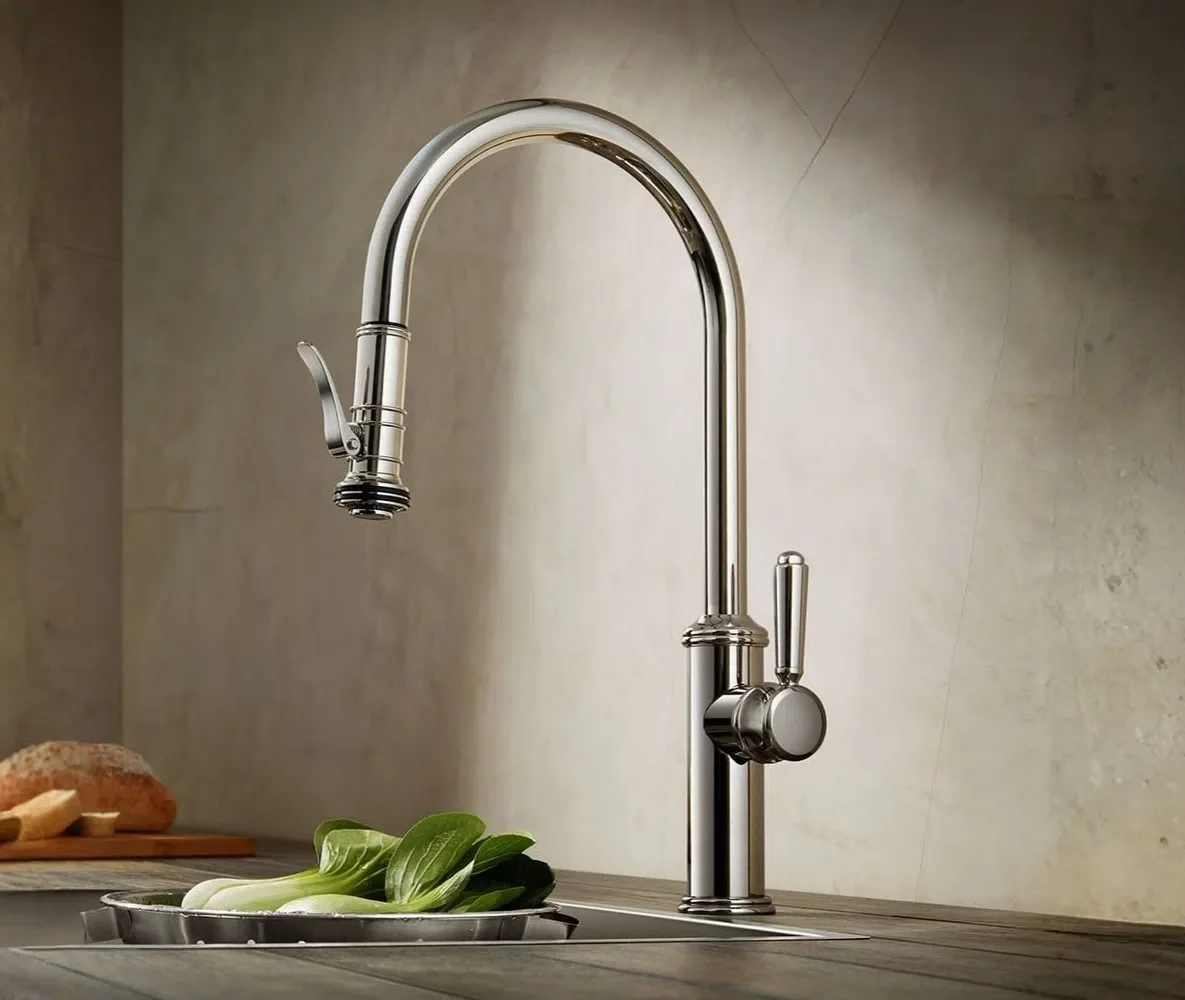 Polished nickel pull-down kitchen faucet with a lever handle above a prep counter