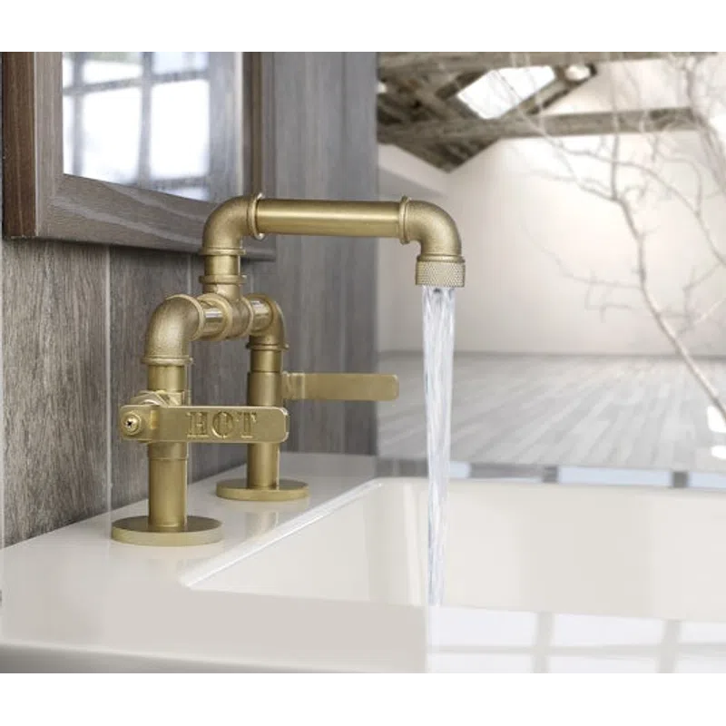 Vintage brass faucet with hot water running into a white sink in a modern rustic bathroom setting.