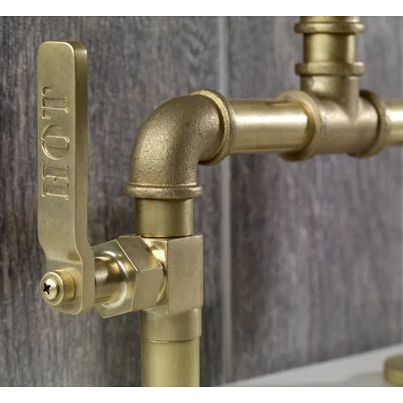 Close-up of a brass plumbing valve with a lever handle against a wooden background