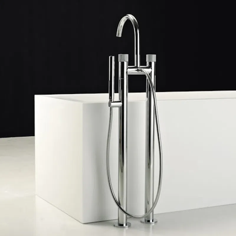 Modern chrome freestanding bathtub faucet with handheld shower against white tub and black background